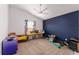 Bedroom boasting a dark blue accent wall and a ceiling fan at 2296 Sheehan St, The Villages, FL 32163