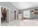 Primary bedroom with walk-in closet, ensuite bath, and large sunny window at 2296 Sheehan St, The Villages, FL 32163