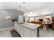 View of the kitchen island, overlooking the adjacent Gathering room and television at 2296 Sheehan St, The Villages, FL 32163