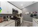 Close up of kitchen, showcasing stainless steel appliances and white cabinets at 2296 Sheehan St, The Villages, FL 32163