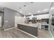 Bright kitchen with white cabinetry, stainless steel appliances, and a spacious gray island at 2296 Sheehan St, The Villages, FL 32163