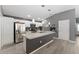 Kitchen boasts white cabinets, granite counters, stainless appliances, and a gray island at 2296 Sheehan St, The Villages, FL 32163