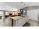 Kitchen island offers extra counter space and overlooks the adjacent living area at 2296 Sheehan St, The Villages, FL 32163