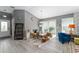 Bright living room with vaulted ceiling, gray walls, laminate flooring, and front door at 2296 Sheehan St, The Villages, FL 32163