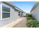 View of the side patio area with neutral siding and a retractable awning at 2296 Sheehan St, The Villages, FL 32163