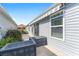 View of the side patio area with storage and mature landscaping around the property at 2296 Sheehan St, The Villages, FL 32163
