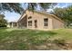 Spacious backyard features a lush lawn and screened lanai, perfect for outdoor relaxation at 2434 Walnut Heights Rd, Apopka, FL 32703
