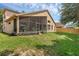 Spacious backyard featuring a screened-in lanai and plenty of space for outdoor activities at 2434 Walnut Heights Rd, Apopka, FL 32703