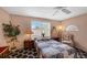Bedroom with large window, ceiling fan, and decorative rug at 2434 Walnut Heights Rd, Apopka, FL 32703