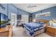 Comfortable bedroom with blue walls and natural light at 2434 Walnut Heights Rd, Apopka, FL 32703