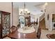 Dining room boasts elegant chandelier and display case, showcasing open floor plan at 2434 Walnut Heights Rd, Apopka, FL 32703
