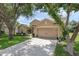 Charming single-story home with a well-manicured lawn, lush landscaping and a 2 car garage at 2434 Walnut Heights Rd, Apopka, FL 32703