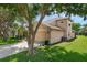 Charming two story home with a well-manicured lawn, lush landscaping and a 2 car garage at 2434 Walnut Heights Rd, Apopka, FL 32703