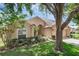 Charming single-story home with a well-manicured lawn, lush landscaping and a 2 car garage at 2434 Walnut Heights Rd, Apopka, FL 32703