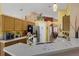 Well-lit kitchen with stainless steel appliances, countertops and view of the dining spaces at 2434 Walnut Heights Rd, Apopka, FL 32703
