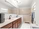 Bathroom featuring double sinks, a walk-in shower, and modern fixtures at 2475 Sw 7Th Ave, Ocala, FL 34471