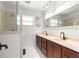 Bright bathroom with double sinks, a large mirror, and a glass-enclosed shower at 2475 Sw 7Th Ave, Ocala, FL 34471