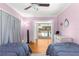 This bedroom features twin beds and an open view to the pool area at 2475 Sw 7Th Ave, Ocala, FL 34471