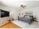 Bright bedroom featuring a ceiling fan, hardwood floors, and a decorative rug at 2475 Sw 7Th Ave, Ocala, FL 34471