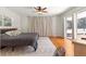 Bedroom showcasing a bed with curtains and sliding glass doors to the pool area at 2475 Sw 7Th Ave, Ocala, FL 34471