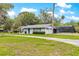 Charming single-story home with lush front yard, a two-car garage, and a screened-in pool area at 2475 Sw 7Th Ave, Ocala, FL 34471