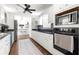Galley kitchen with white cabinets, black countertops, and stainless steel appliances at 2475 Sw 7Th Ave, Ocala, FL 34471