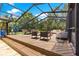 Expansive screened-in pool deck with dining and lounging areas, perfect for enjoying outdoor living at 2475 Sw 7Th Ave, Ocala, FL 34471