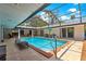 Beautiful screened-in pool and patio area with ample seating and space for outdoor living at 2475 Sw 7Th Ave, Ocala, FL 34471
