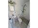 Cozy bathroom featuring white tile, a pedestal sink, and a walk-in shower at 3740 Ne 5Th St, Ocala, FL 34470