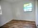 Bedroom featuring new wood floors, white walls, and natural light from the windows at 3740 Ne 5Th St, Ocala, FL 34470