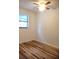 This bedroom features wood-look flooring, a ceiling fan, and a window for natural light at 3740 Ne 5Th St, Ocala, FL 34470