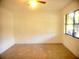 An empty bedroom featuring tiled flooring and a bright window at 3740 Ne 5Th St, Ocala, FL 34470