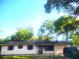 Well-kept home with a one car garage, manicured lawn, and mature trees at 3740 Ne 5Th St, Ocala, FL 34470