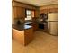 Kitchen featuring stainless steel appliances, wooden cabinetry, and tile flooring at 3740 Ne 5Th St, Ocala, FL 34470