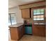 Spacious kitchen with wooden cabinets, a peninsula counter, and a view of the pool at 3740 Ne 5Th St, Ocala, FL 34470