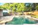 Backyard pool with mature trees providing privacy and a wooden fence at 3740 Ne 5Th St, Ocala, FL 34470