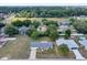 Wide aerial shot showing the home's placement within a neighborhood with tree coverage and surrounding community features at 4331 Se 106Th Pl, Belleview, FL 34420