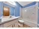 Bathroom with white vanity, toilet, and tub/shower combination at 4331 Se 106Th Pl, Belleview, FL 34420