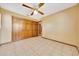 Bedroom featuring tile flooring, ceiling fan, and closet at 4331 Se 106Th Pl, Belleview, FL 34420