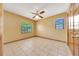 Bright bedroom featuring two windows, ceiling fan, and tile flooring at 4331 Se 106Th Pl, Belleview, FL 34420