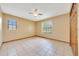 Cozy bedroom with tile flooring, natural light, and a ceiling fan at 4331 Se 106Th Pl, Belleview, FL 34420