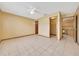 Spacious bedroom with a ceiling fan, tiled flooring, and access to a closet at 4331 Se 106Th Pl, Belleview, FL 34420