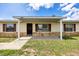 Inviting covered front porch with stone accents, offering a welcoming entrance to the home at 4331 Se 106Th Pl, Belleview, FL 34420