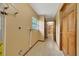 Hallway leading to the kitchen, featuring a window for natural light at 4331 Se 106Th Pl, Belleview, FL 34420