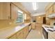 Well-lit kitchen with a view into a living room featuring a stone fireplace at 4331 Se 106Th Pl, Belleview, FL 34420
