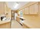 Traditional kitchen featuring wood cabinets, laminate countertops, and modern appliances at 4331 Se 106Th Pl, Belleview, FL 34420