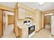 Cozy kitchen with wooden cabinets and access to adjacent rooms at 4331 Se 106Th Pl, Belleview, FL 34420