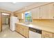Bright kitchen with wood cabinets, double sink, and modern appliances, offering a functional layout at 4331 Se 106Th Pl, Belleview, FL 34420