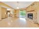 Living room featuring a stone fireplace, sliding glass doors, and a breakfast bar to the kitchen at 4331 Se 106Th Pl, Belleview, FL 34420