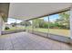 Screened patio features tile flooring with views of the backyard at 4331 Se 106Th Pl, Belleview, FL 34420